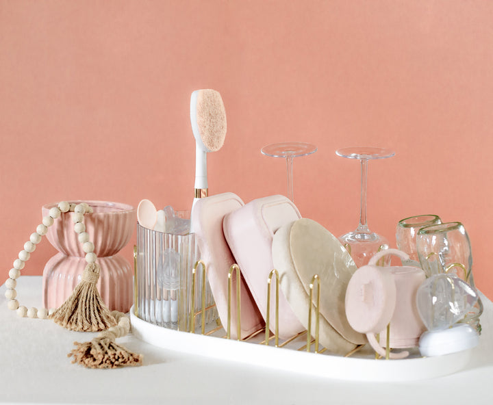Gold countertop dish drying rack with upright glassware and included cleaning accessories