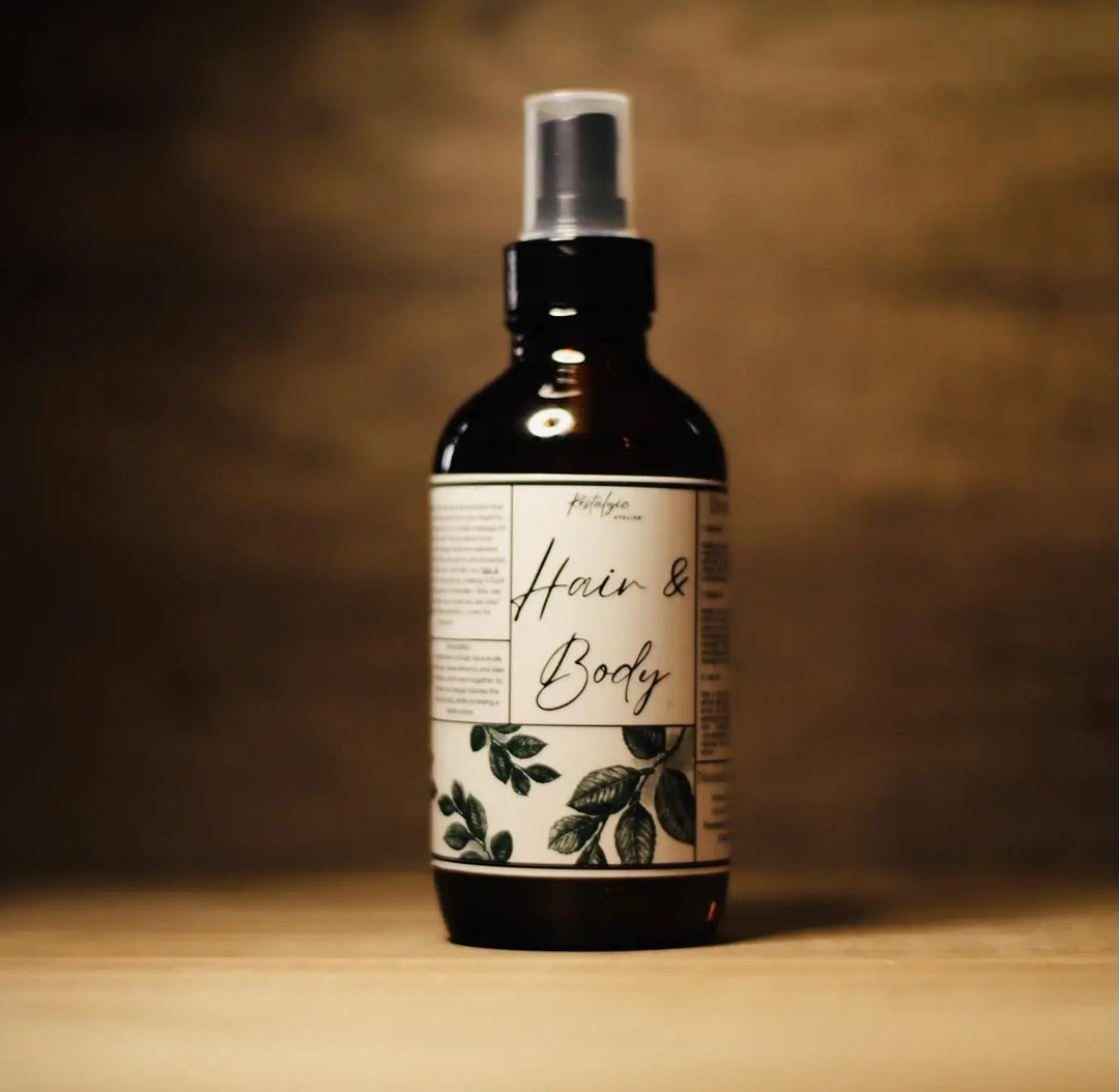 All-natural hair and body oil bottle with botanical label and pump spray top