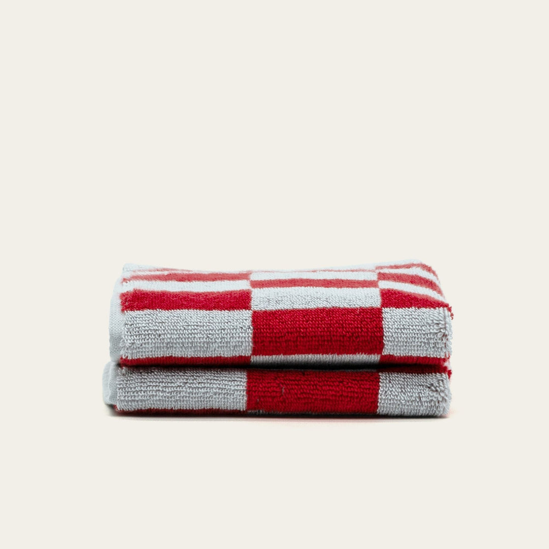 Folded red and white check cotton towel set.