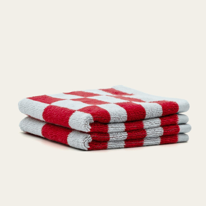 Stack of red and white buffalo check cotton towels.