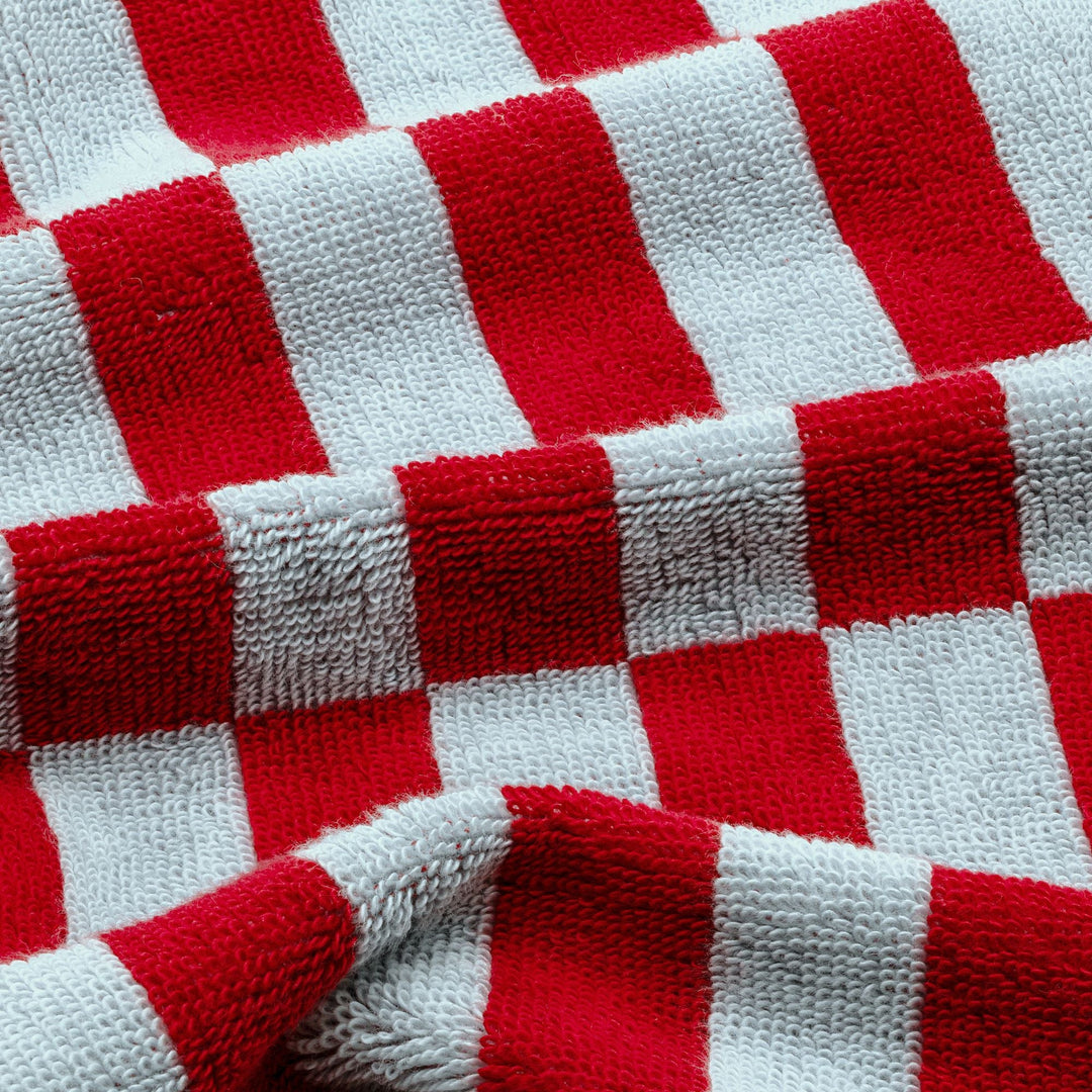 Close-up of red and white buffalo check cotton towel fabric.