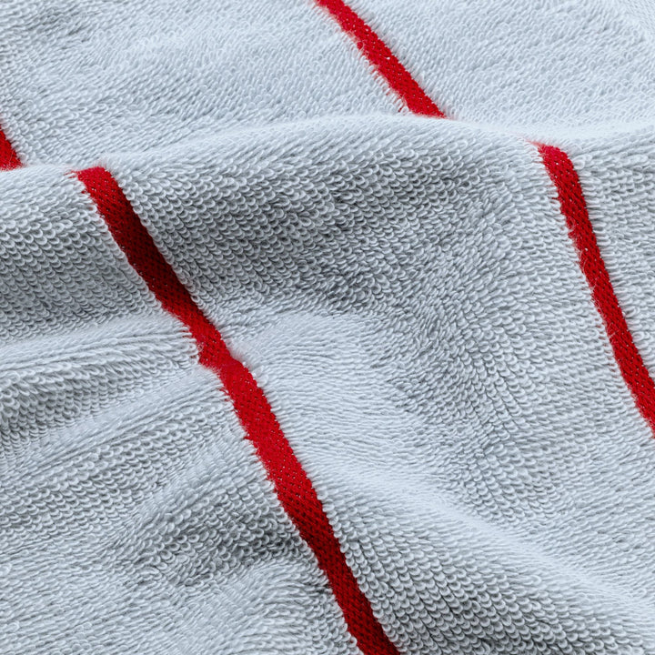 Close-up light blue cotton towel with red vertical stripe detail