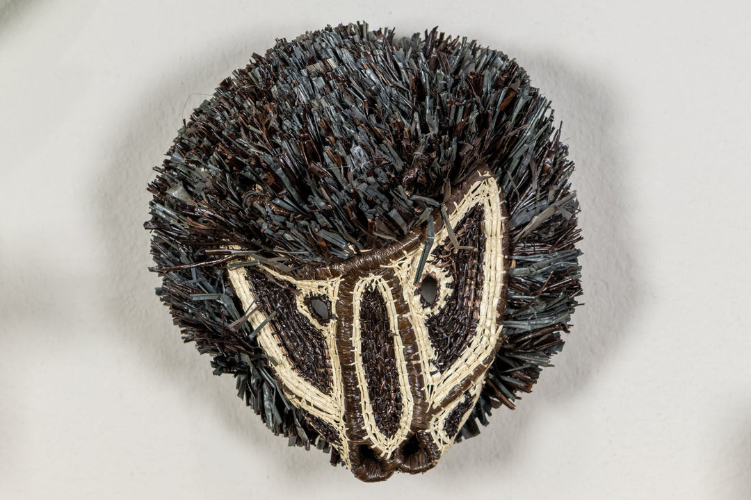 Black and white colobus monkey face mask with dark fringe and cream embroidered stripes