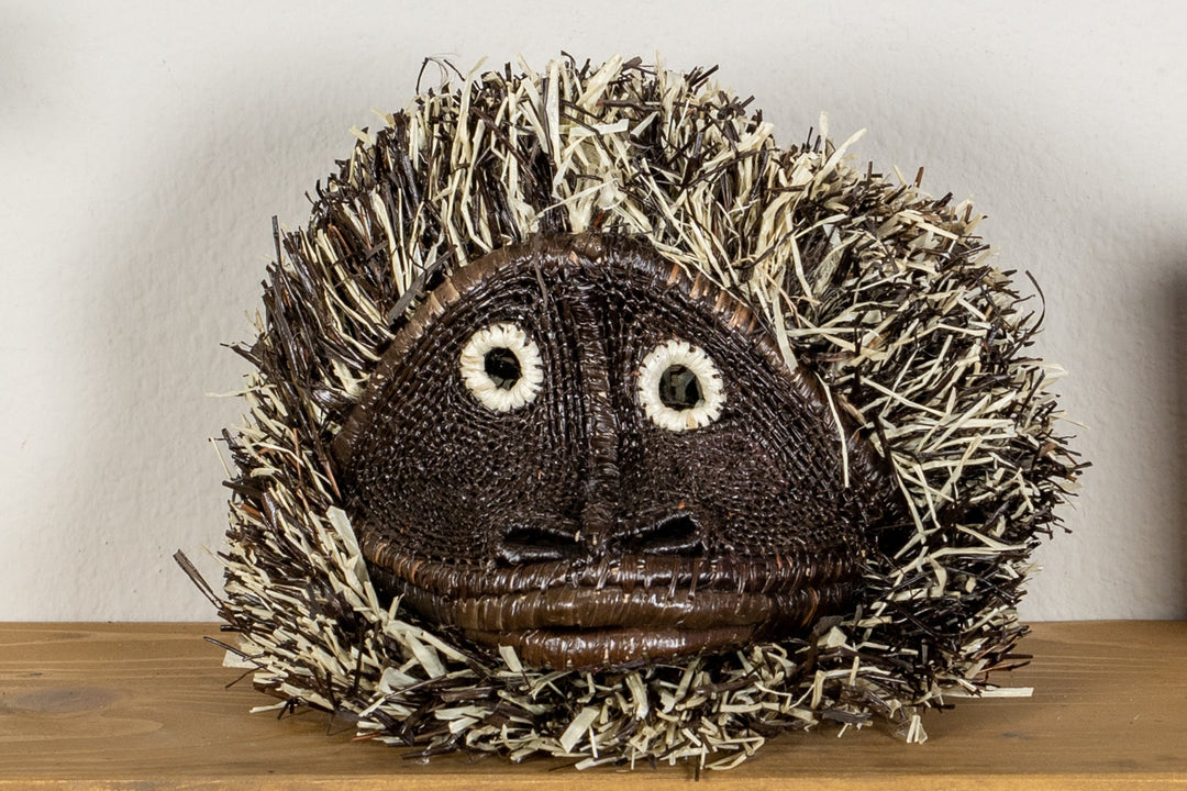 Tufted capuchin monkey mask with embroidered eyes and tufted shag hood.