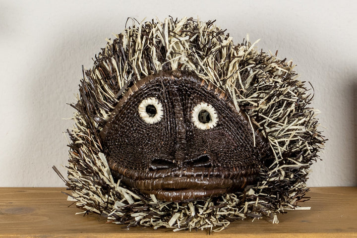 Tufted capuchin monkey mask with embroidered eyes and tufted shag hood.