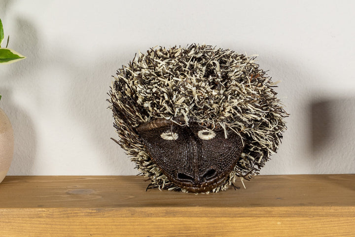 Tufted capuchin monkey mask, close view of tufted hood and embroidered eyes.