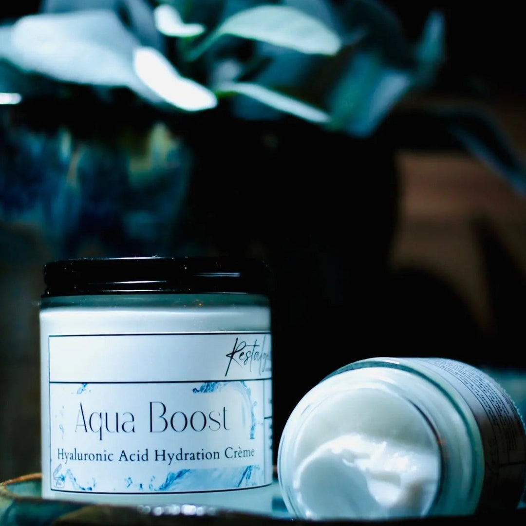 Aqua Boost hyaluronic acid hydration crème jars, one upright and one lying down