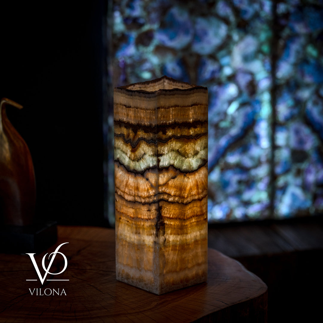 Small table lamp with square live-edge wood base in warm amber and dark brown