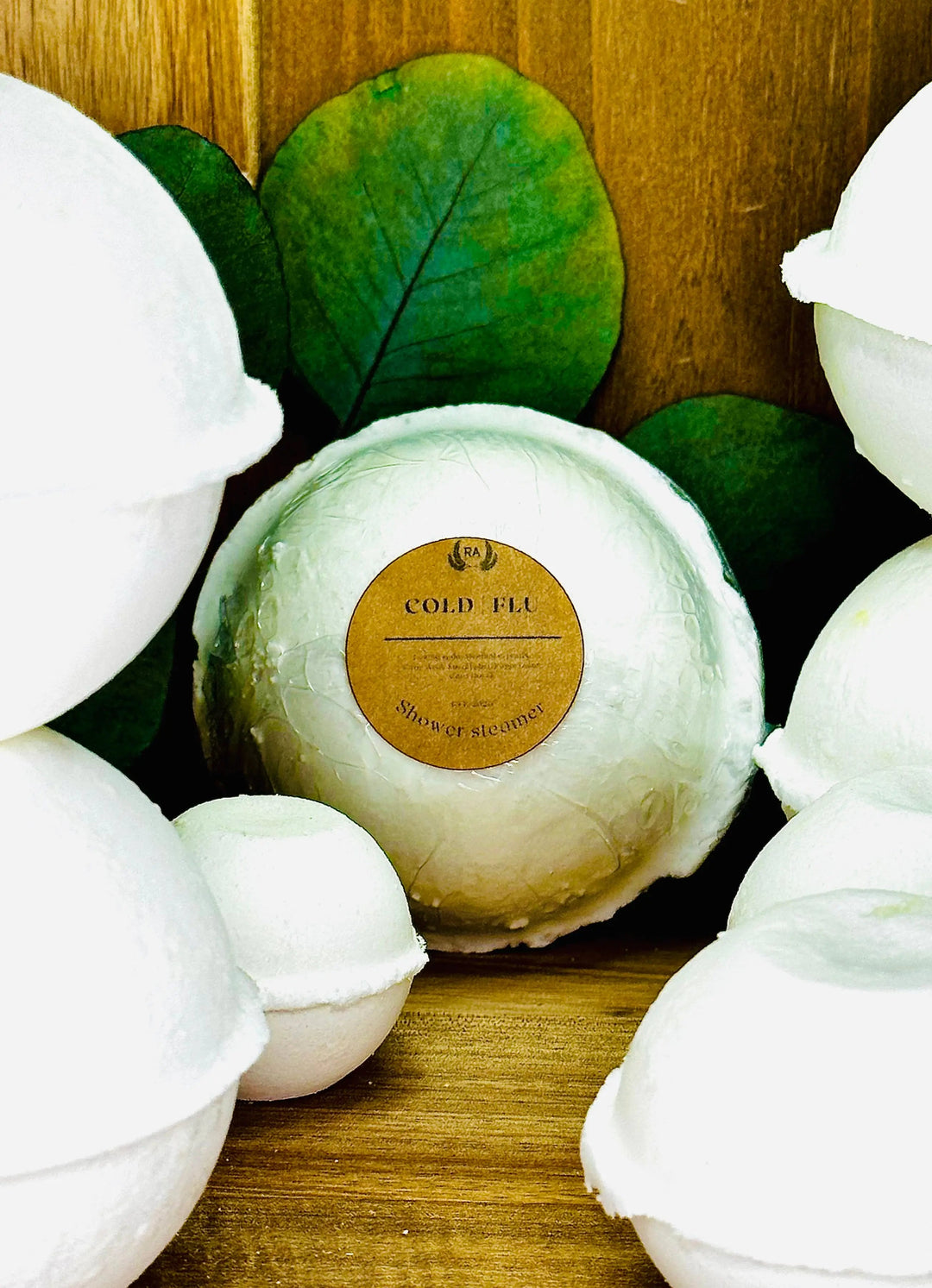 White round shower steamer discs with green leaf accents