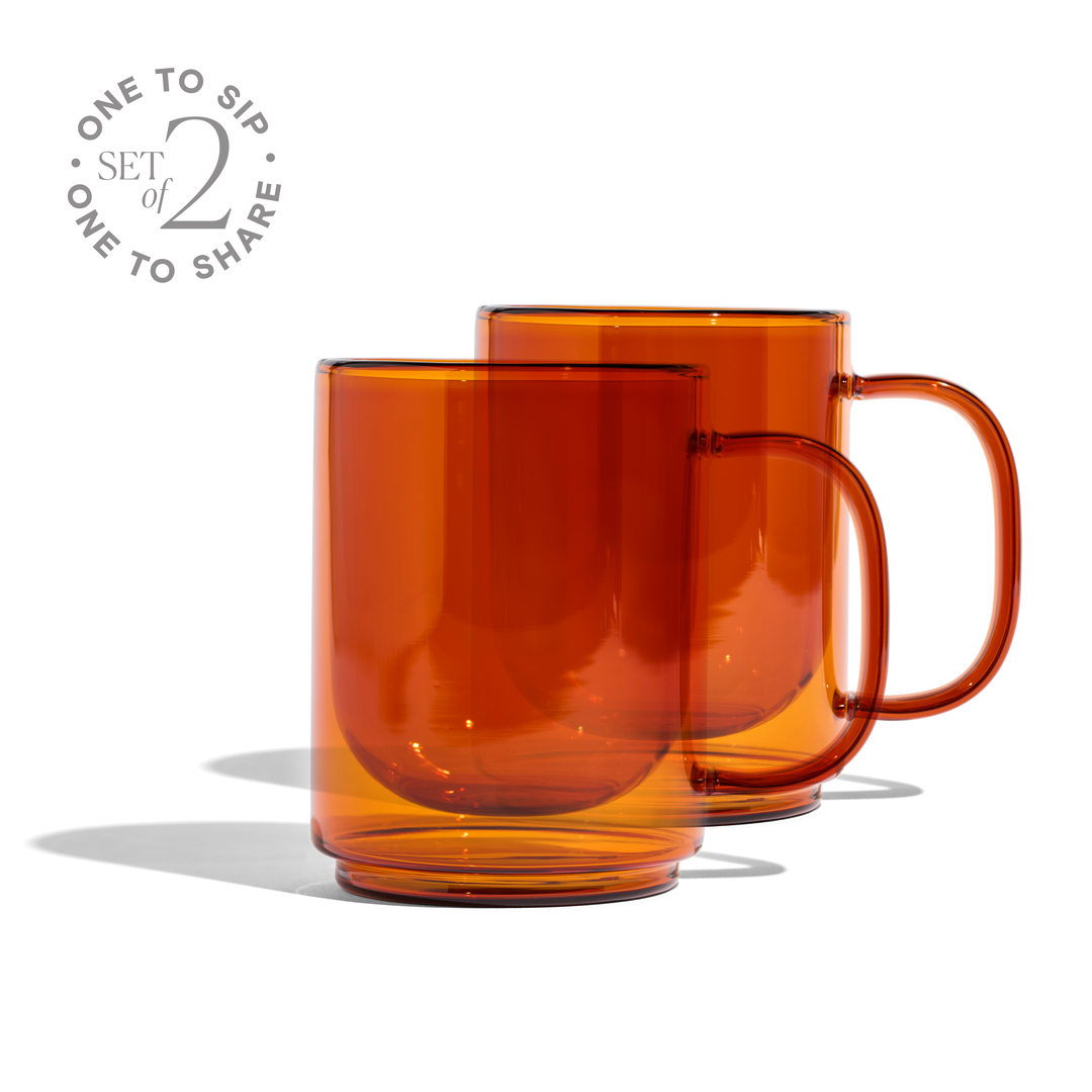 Set of 2 amber glass mugs with curved handles, glossy transparent cups
