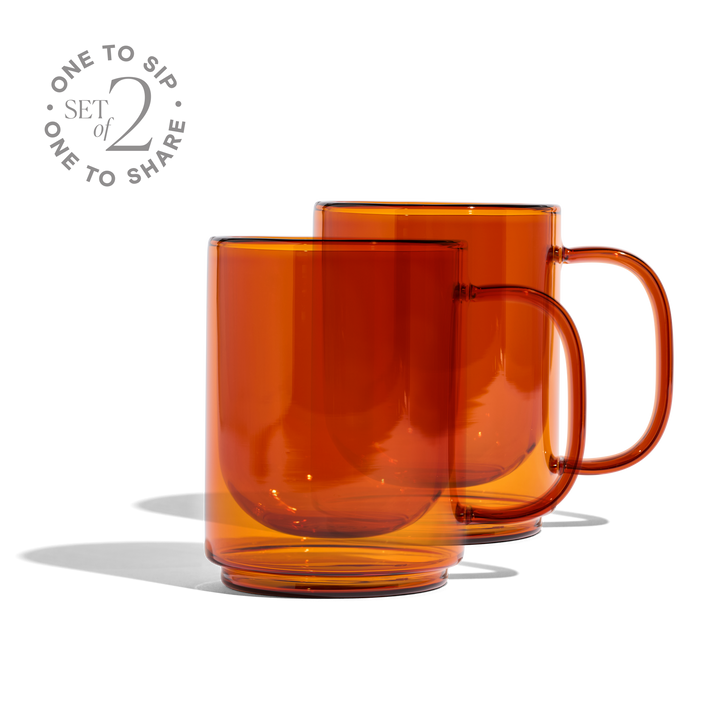 Set of 2 amber glass mugs with curved handles, glossy transparent cups