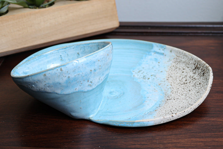 Coastal ceramic serving bowl with blue interior and beige speckled outer glaze