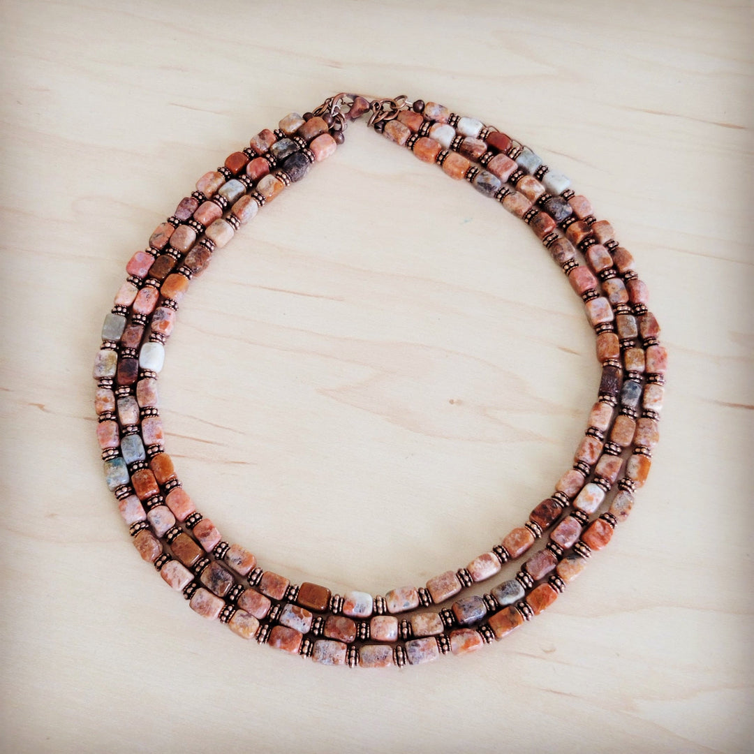 Layered beaded collar necklace with multi-row square beads and dark cube beads in rust tones