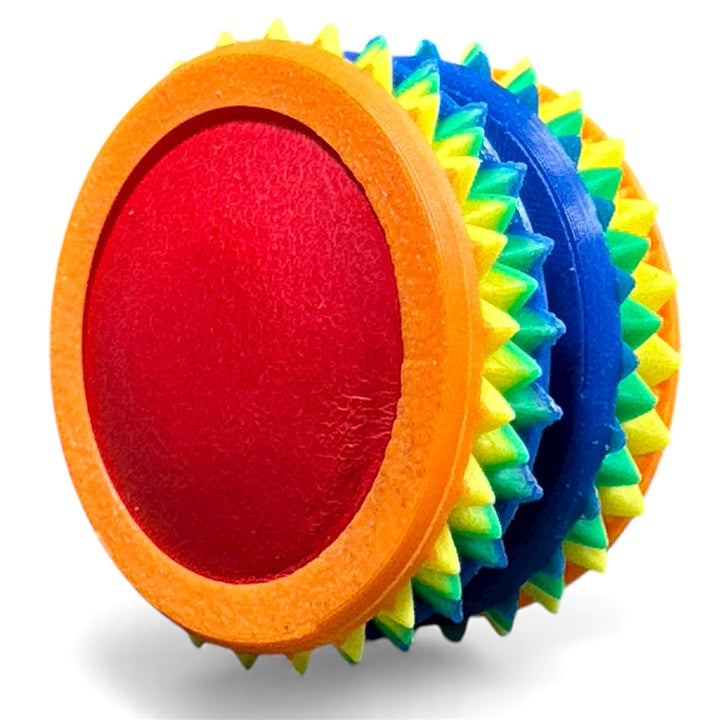 Orange and rainbow fidget moon toy with red oval center and spiky edges