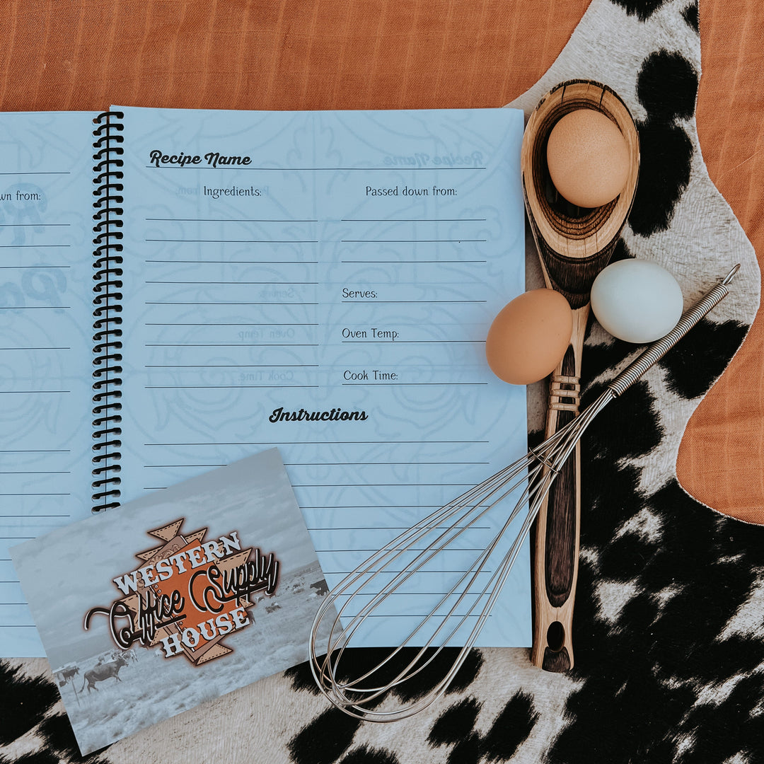 Recipe book open to a blue blank recipe page with ingredient lines and instructions