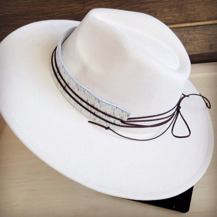 White wide-brim felt hat with gray spotted band and dark bow tie detail