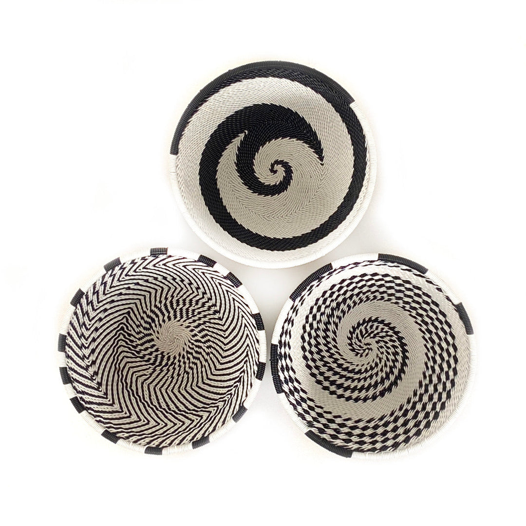 Set of three small woven wire basket bowls with black-and-white spiral designs