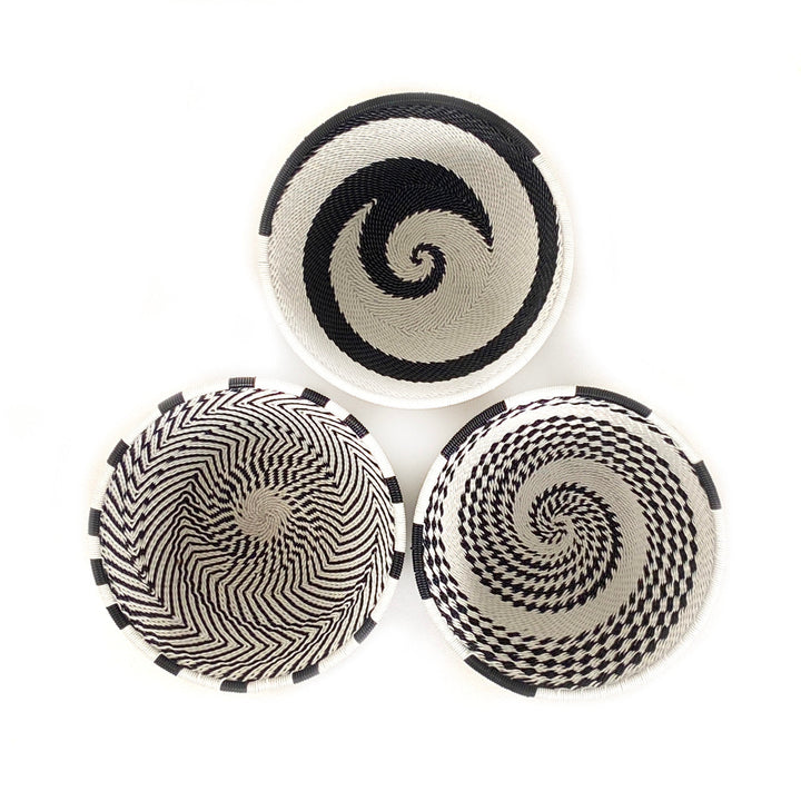Set of three small woven wire basket bowls with black-and-white spiral designs