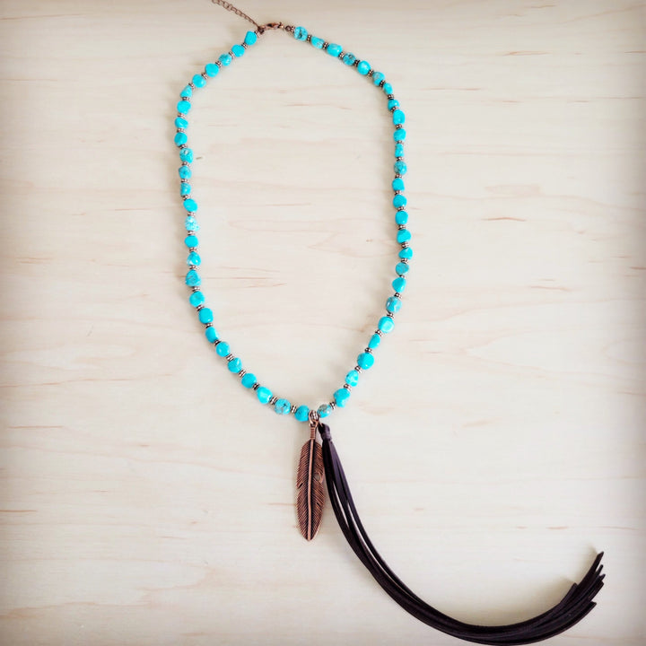 Turquoise beaded necklace with feather pendant and black leather tassel