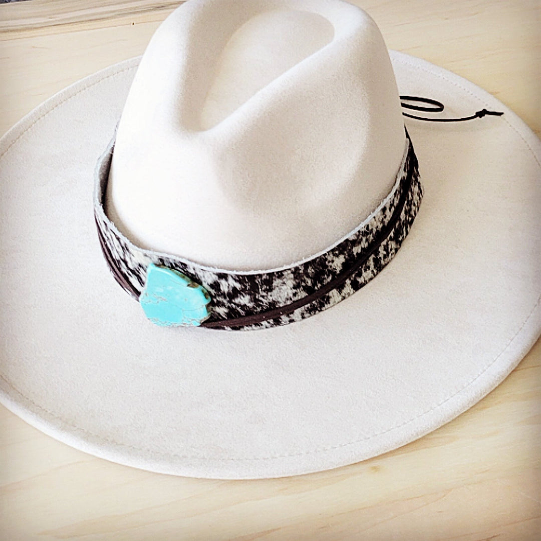 Wide-brim white hat with black spotted leather band and turquoise heart accent
