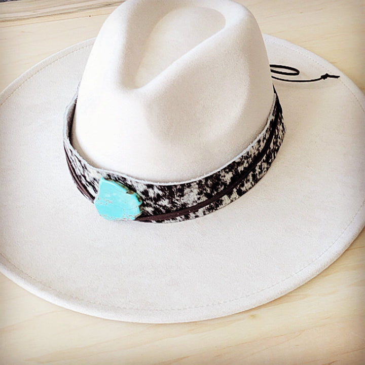 Wide-brim white hat with black spotted leather band and turquoise heart accent
