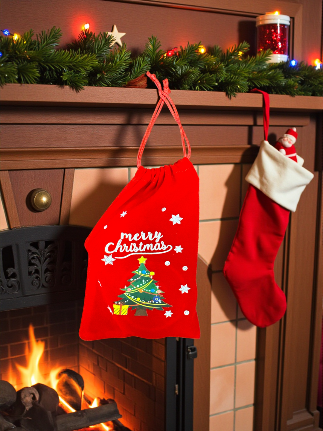 Red drawstring Christmas gift bag with “Merry Christmas” and tree print