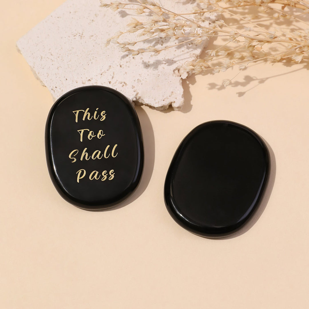 Black oval crystal stone with gold “This Too Shall Pass” text