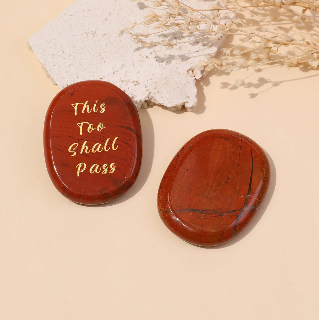 Red oval crystal stones with gold “This Too Shall Pass” inscription