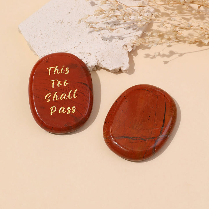 Red oval crystal stones with gold “This Too Shall Pass” inscription