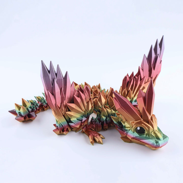 Pink and rainbow crystal-wing baby dragon fidget toy with faceted scales and wings