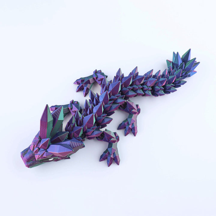 Articulated crystal baby dragon fidget toy with dark purple and teal facets
