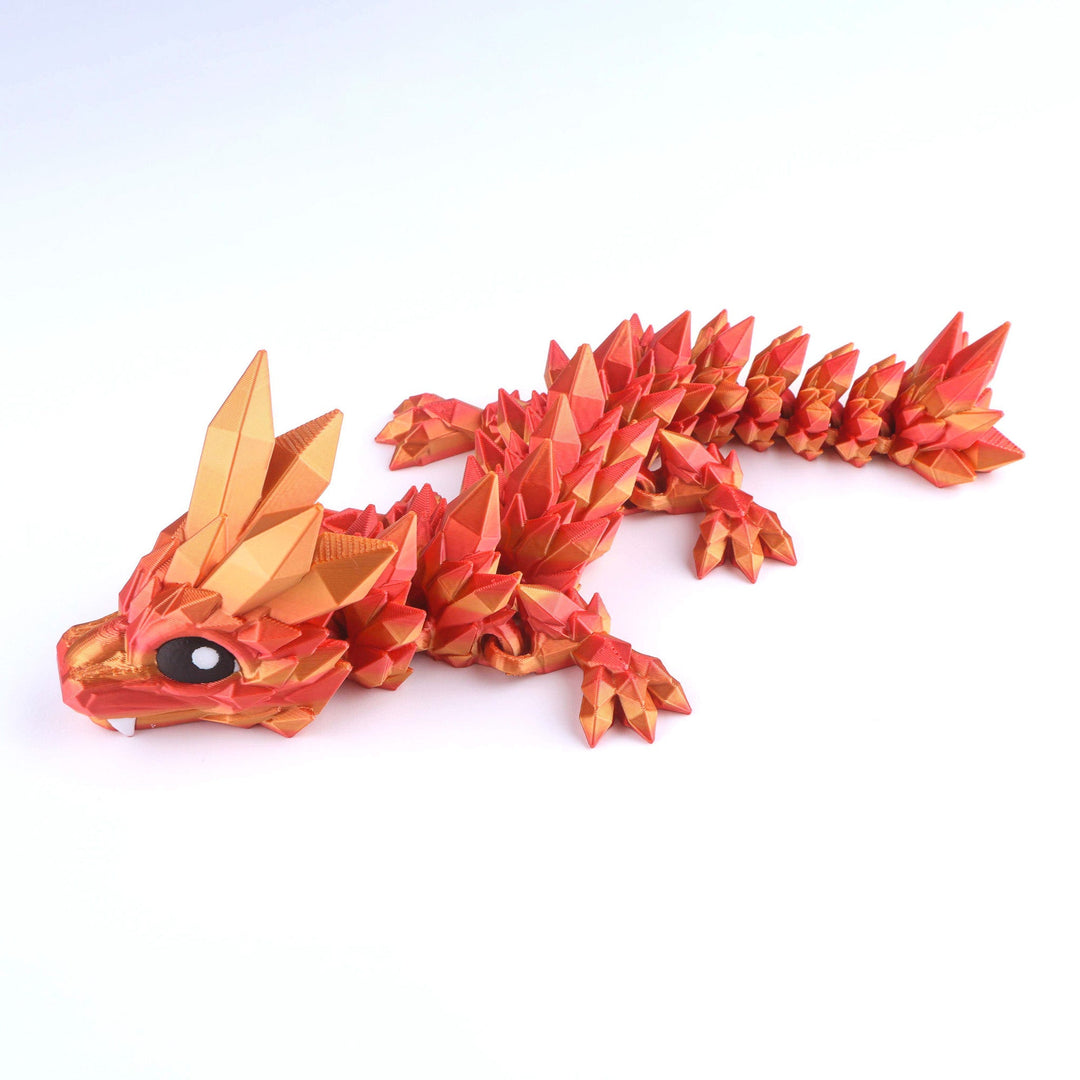 Articulated crystal baby dragon fidget toy in bright red-orange with white eye