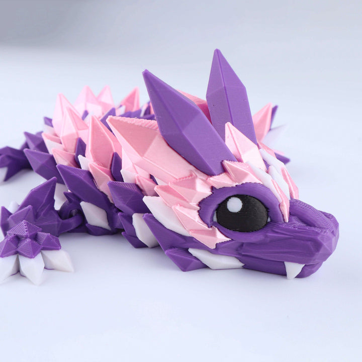 Articulated crystal baby dragon fidget toy with purple and pink facets