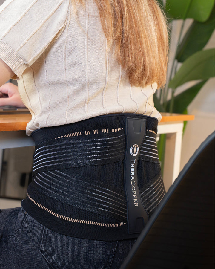 Black lumbar back brace with copper stripes and vertical central support panel