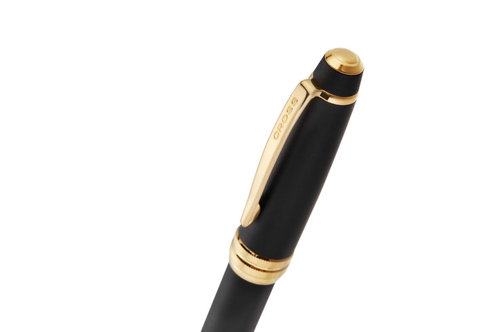 Matte black ballpoint pen top with gold PVD cap and gold trim