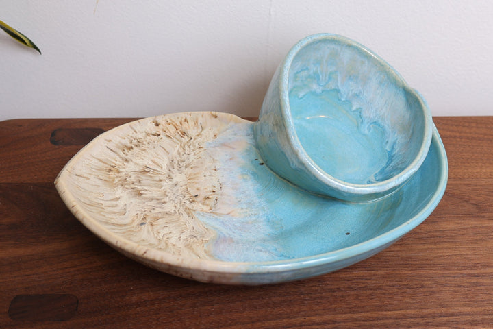 Coastal ceramic bowl set with blue interior and beige speckled base, viewed from side