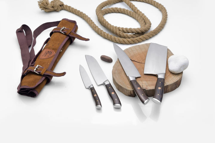 Kitchen knife set in brown leather roll with rope tie and dark-handled blades