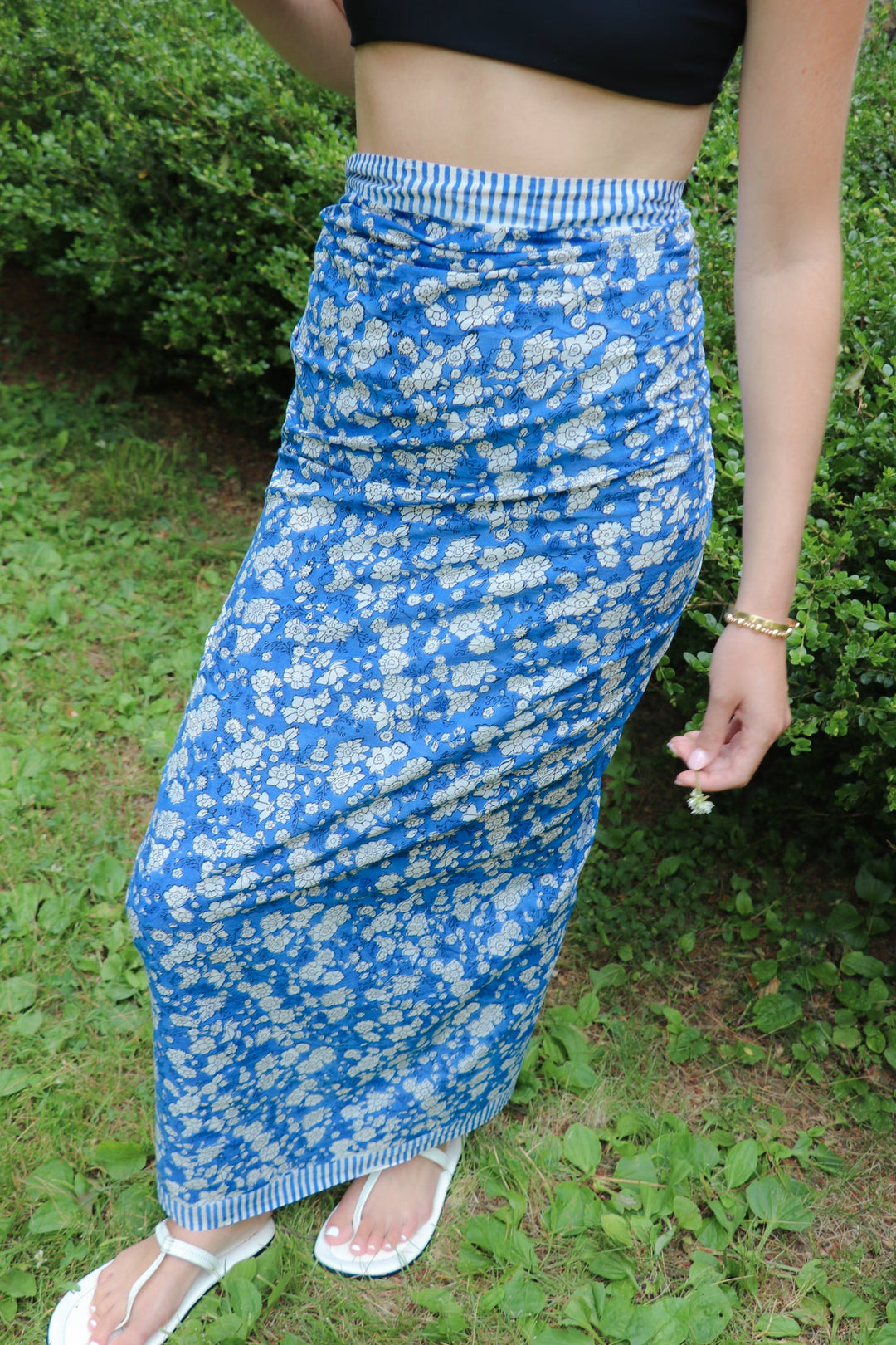 Blue floral pareo wrap skirt detail with striped elastic waistband and draped fabric