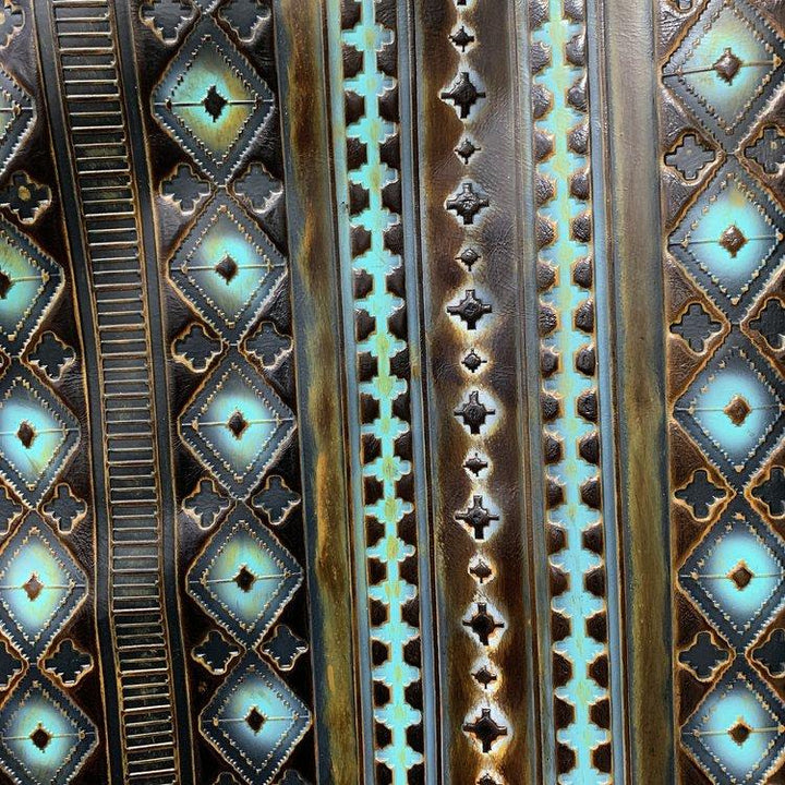 Close-up of turquoise, gold, and black leather Navajo-style hat band pattern