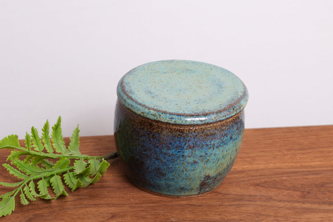 Ceramic butter dish with teal speckled lid, round storage container