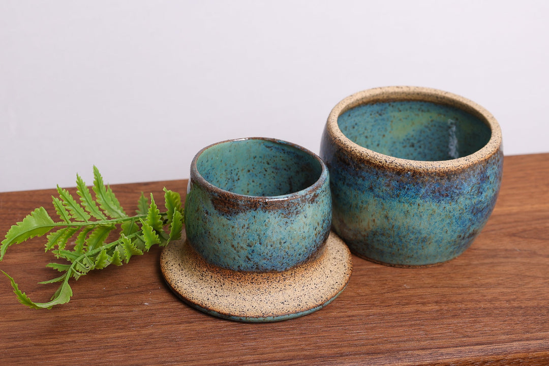Ceramic butter dish set with two teal bowls and plate, speckled glaze