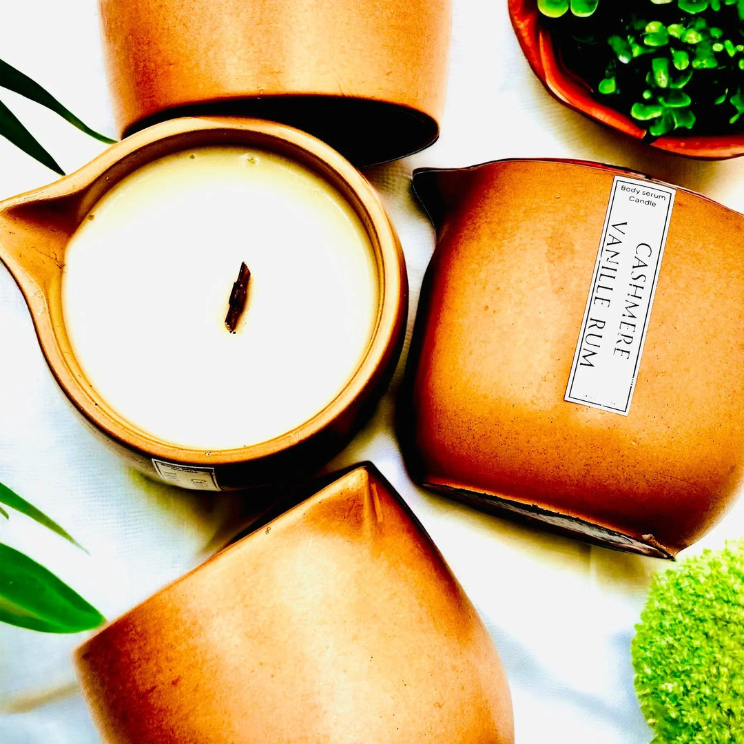 Body oil serum candle in amber jar with white wax and visible wick