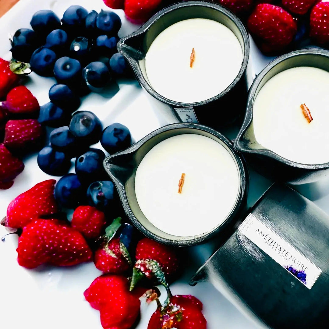 Body oil serum candle in dark metal cups with white wax and exposed wicks