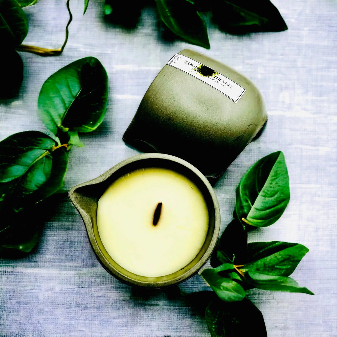 Body oil serum candle in lime-green container with white wax and central wick