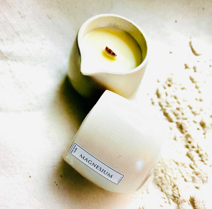 Body oil serum candle pair in pale containers with white wax and exposed wicks