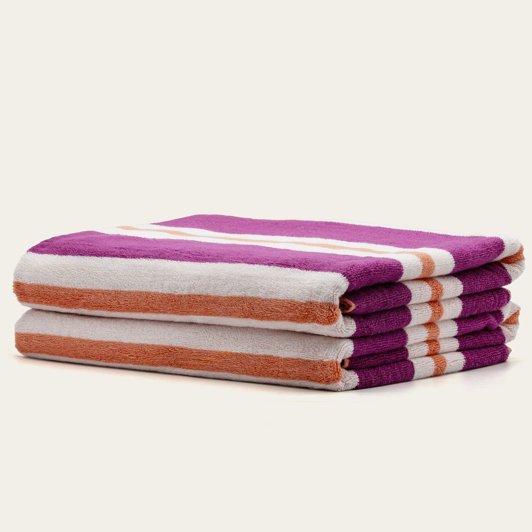 Cotton beach towel set, stacked purple, cream, and orange striped towels