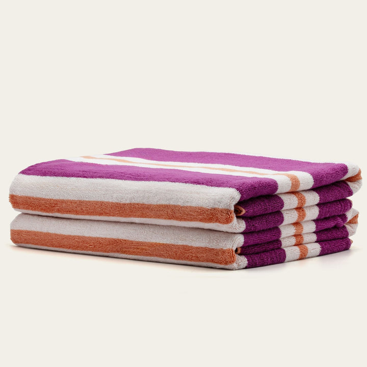 Cotton beach towel set, stacked purple, cream, and orange striped towels