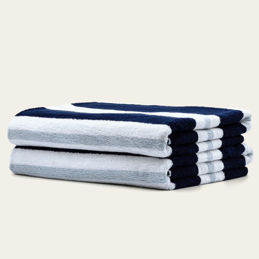 Cotton beach towels stacked with light gray body and navy striped ends