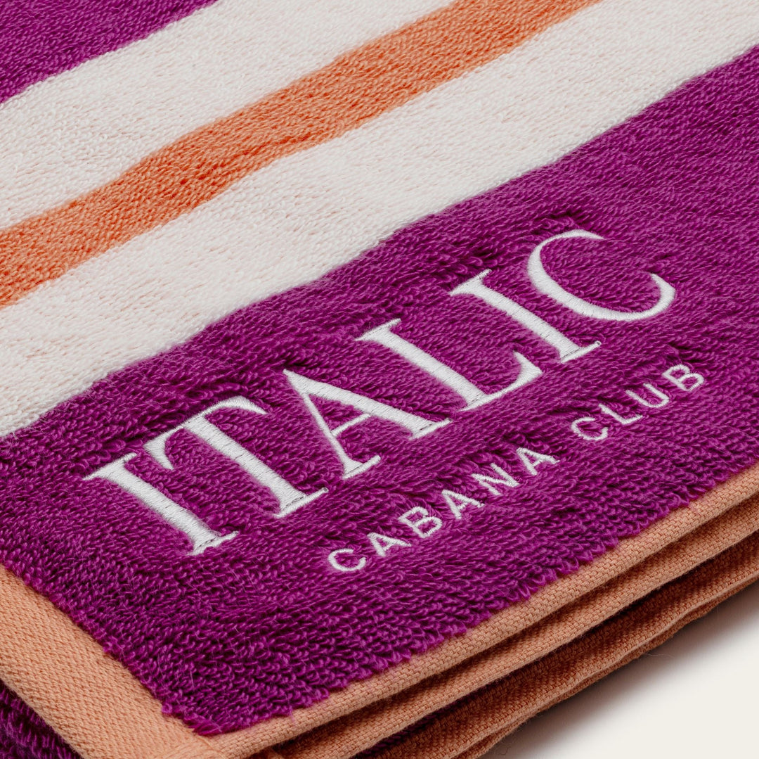 Purple striped cotton beach towel with ITALIC Caban Club logo text