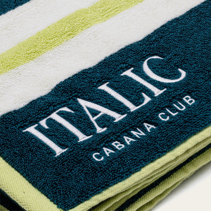 Navy cotton beach towel band with white "ITALIC" and "CABANA CLUB" text